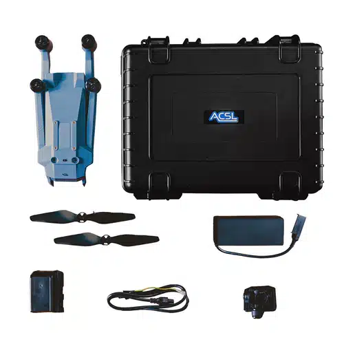 Drone kit laid out with a black ACSL hard case, folded blue drone frame, two extra propellers, battery, charger, and cables.